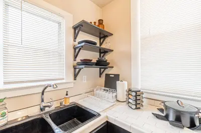 a kitchen with a sink and two windows at Rustic Studio walking distance to Downtown in Reno