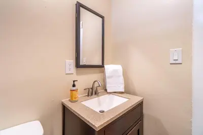 a bathroom with a sink and a mirror at Rustic Studio walking distance to Downtown in Reno