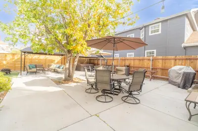 a patio with a table and chairs and an umbrella at Rustic Studio walking distance to Downtown in Reno
