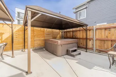 a barbecue under an umbrella on a patio at Rustic Studio walking distance to Downtown in Reno