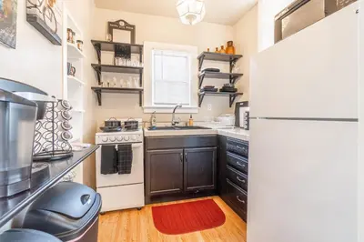 a kitchen with a sink and a refrigerator at Rustic Studio walking distance to Downtown in Reno