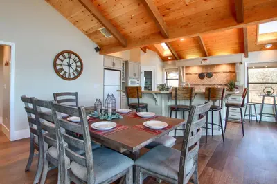 a kitchen and dining room with a table and chairs at NEW! Yosemite Mountain villa, stunning views -more in Oakhurst
