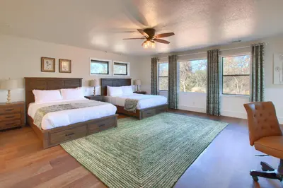 a bedroom with two beds and a ceiling fan at NEW! Yosemite Mountain villa, stunning views -more in Oakhurst