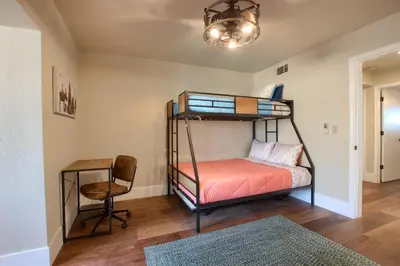 a bedroom with two bunk beds and a chair at NEW! Yosemite Mountain villa, stunning views -more in Oakhurst