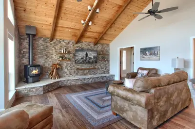 a living room with a couch and a fireplace at NEW! Yosemite Mountain villa, stunning views -more in Oakhurst