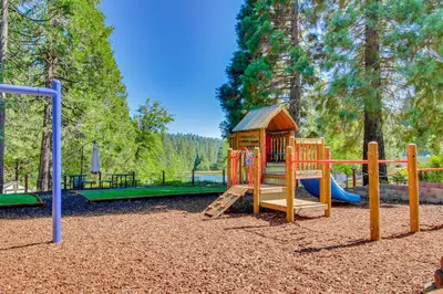 a wooden playground with a slide and a slideintend at Vacation Valhalla in Arnold