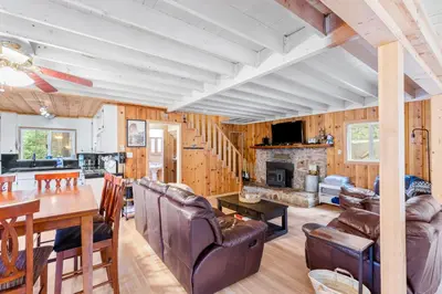 a dining room and living room with a fireplace at Vacation Valhalla in Arnold