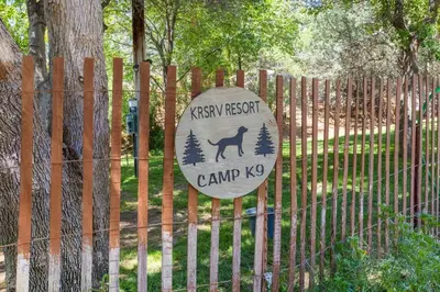a sign on a fence with a dog on it at Quiet little pet friendly cabin in Kernville
