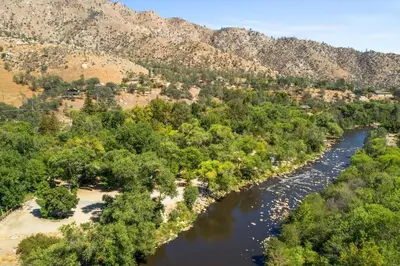 an aerial view of a river with trees and mountains at Quiet little pet friendly cabin in Kernville