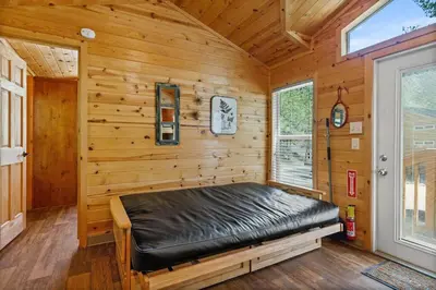 a room with a bed in a log cabin at Adorable little cabin #26 in Kernville