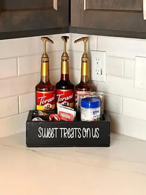 a shelf with four bottles of alcohol on a kitchen counter at Deluxe little cabin 2 min stroll to Kern River in Kernville