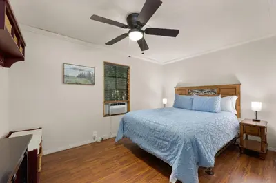 a bedroom with a bed and a ceiling fan at The Sequoia House in Kernville