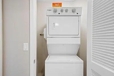 a white stove in a small room with a refrigerator at Designer Apt w Jacuzzi Walk To Casino & iMax in Sparks