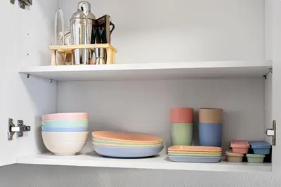 a shelf with bowls and vases on it at Designer Apt w Jacuzzi Walk To Casino & iMax in Sparks