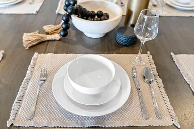 a table with a white plate and a bowl of grapes at Designer Apt w Jacuzzi Walk To Casino & iMax in Sparks