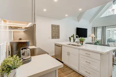 a kitchen with white cabinets and a sink at Crystal Bay Comfort in Incline Village
