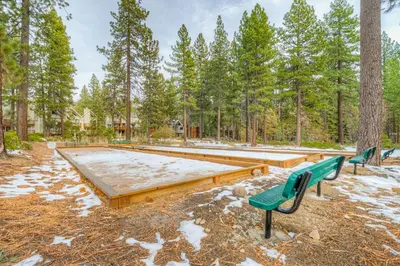 a group of benches in a park with trees at Crystal Bay Comfort in Incline Village