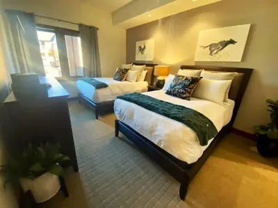 a hotel room with two beds and a couch at Ski In/Out - Zalanta - Great Location- 2 Hot Tubs - Heated Pool in South Lake Tahoe