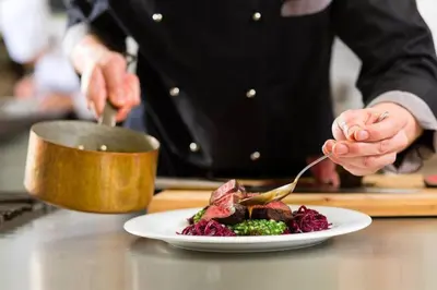 a chef preparing a plate of food on a table at Ski In/Out - Zalanta - Great Location- 2 Hot Tubs - Heated Pool in South Lake Tahoe