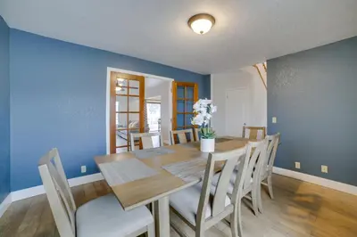 a dining room with a wooden table and blue walls at Pet-Friendly Hollister Getaway with Grill! in Hollister