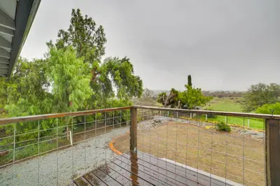 a balcony with a fence and a field at Pet-Friendly Hollister Getaway with Grill! in Hollister