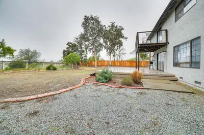 an empty yard with a fence and a building at Pet-Friendly Hollister Getaway with Grill! in Hollister
