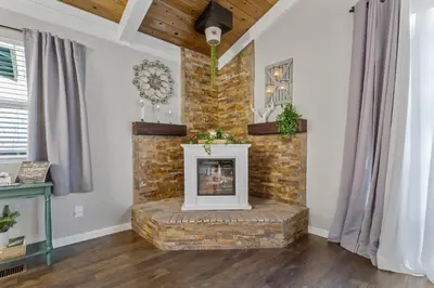 a fireplace in a living room with a brick wall at Fully-Stocked, Pet-friendly, Relaxing Home Near Yosemite and Bass Lake in North Fork