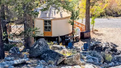 a tiny house in the woods with trees and rocks at Desolation Hotel Hope Valley in Markleeville