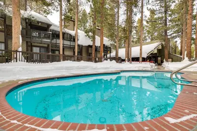 a swimming pool in the snow in front of a resort at Mammoth Lakes Condo about 5 Mi to Mammoth Mtn! in Mammoth Lakes