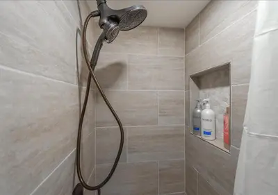 a shower with a shower head in a bathroom at Northstar Village Condo Walk to Lifts 2 Full BA Excellent Location Hot-Tubs in Truckee