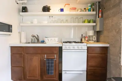 a kitchen with a white stove and a sink at Modern lofty studio in Midtown / Charming Old SW in Reno