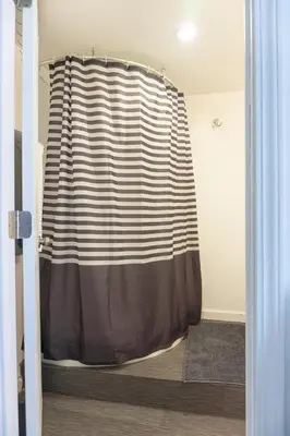 a shower curtain in a room with a door at Modern lofty studio in Midtown / Charming Old SW in Reno