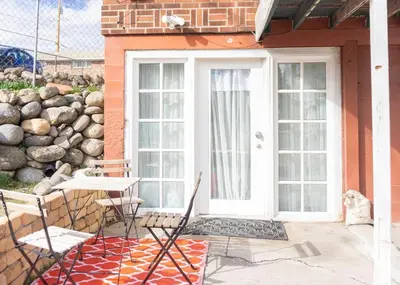 a patio with two chairs and a white door at Modern lofty studio in Midtown / Charming Old SW in Reno