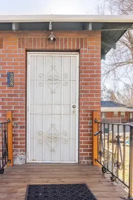a white garage door on a brick building at Midcentury Gem in Midtown Reno in Reno