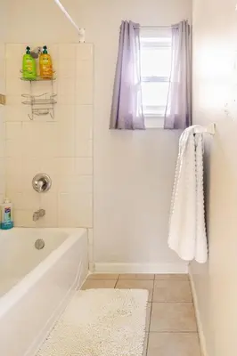 a bathroom with a tub and a window at Midcentury Gem in Midtown Reno in Reno