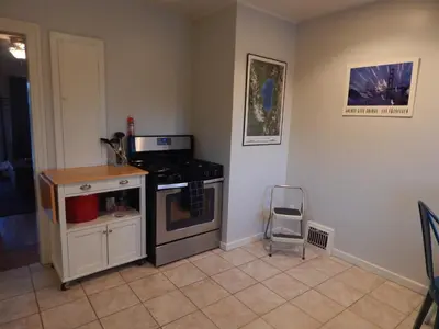 a kitchen with a stove and a chair in it at Midcentury Gem in Midtown Reno in Reno