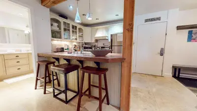 a kitchen with a counter and some stools in it at Summit #92 condo in Mammoth Lakes