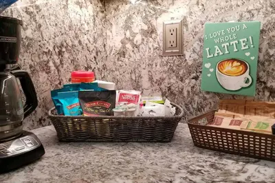 two baskets of food on a counter next to a coffee maker at Chateau Sunnyside in Fresno