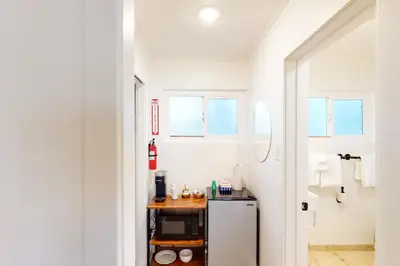 a white kitchen with a small refrigerator and windows at The Chalet at Kings Beach 9 in Kings Beach