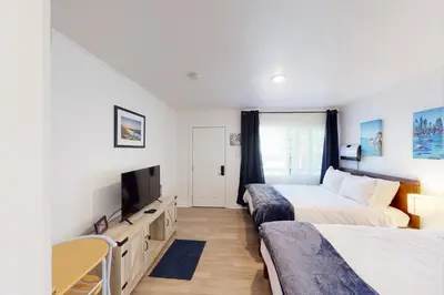 a bedroom with two beds and a flat screen tv at The Chalet at Kings Beach 9 in Kings Beach