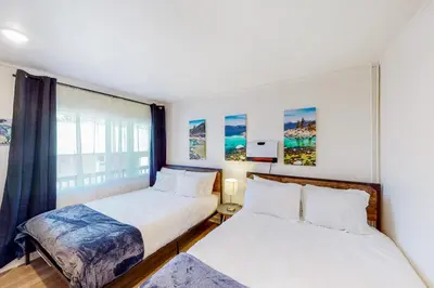 two beds in a room with a window at The Chalet at Kings Beach 9 in Kings Beach