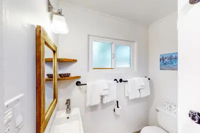 a white bathroom with a sink and a mirror at The Chalet at Kings Beach 9 in Kings Beach