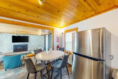 a kitchen with a table and a refrigerator at The Chalet at Kings Beach 9 in Kings Beach