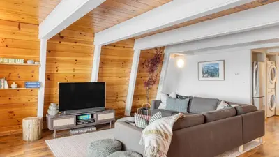 a living room with a couch and a flat screen tv at Chickaree Chickadee Buyout by AvantStay 2 Sister Cabins in Tahoe City