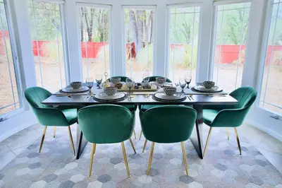 a dining room with a table and green chairs at Mountain Escape, Yosemite South Gate House with Hot Tub, Views & Game Room, Near town in Oakhurst