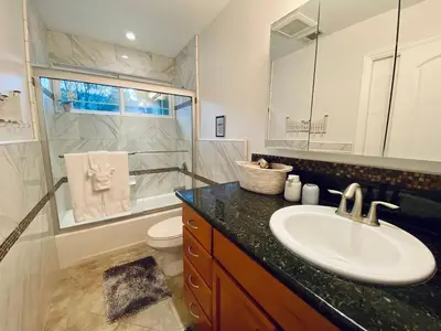a bathroom with a sink and a toilet and a mirror at Mountain Escape, Yosemite South Gate House with Hot Tub, Views & Game Room, Near town in Oakhurst