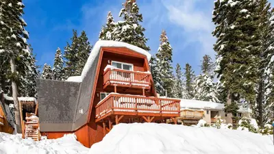 a cabin in the snow with a deck at Chickadee by AvantStay Modern A-Frame Cabin in Tahoe City