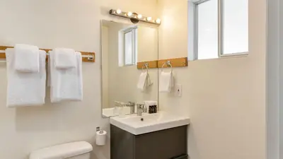 a bathroom with a sink and a toilet and a mirror at Chickaree by AvantStay A-Frame w Mountain Views in Tahoe City