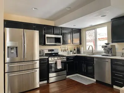 a kitchen with black cabinets and stainless steel appliances at Reno Gem 3 and a half Miles to DT, 40 Miles to Tahoe in Reno