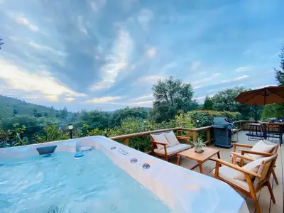 a swimming pool with chairs and a table and an umbrella at Cozy Cabin Near Yosemite & Bass lake, Breathtaking Views & Private Hot Tub, BBQ, Nature Getaway in Oakhurst
